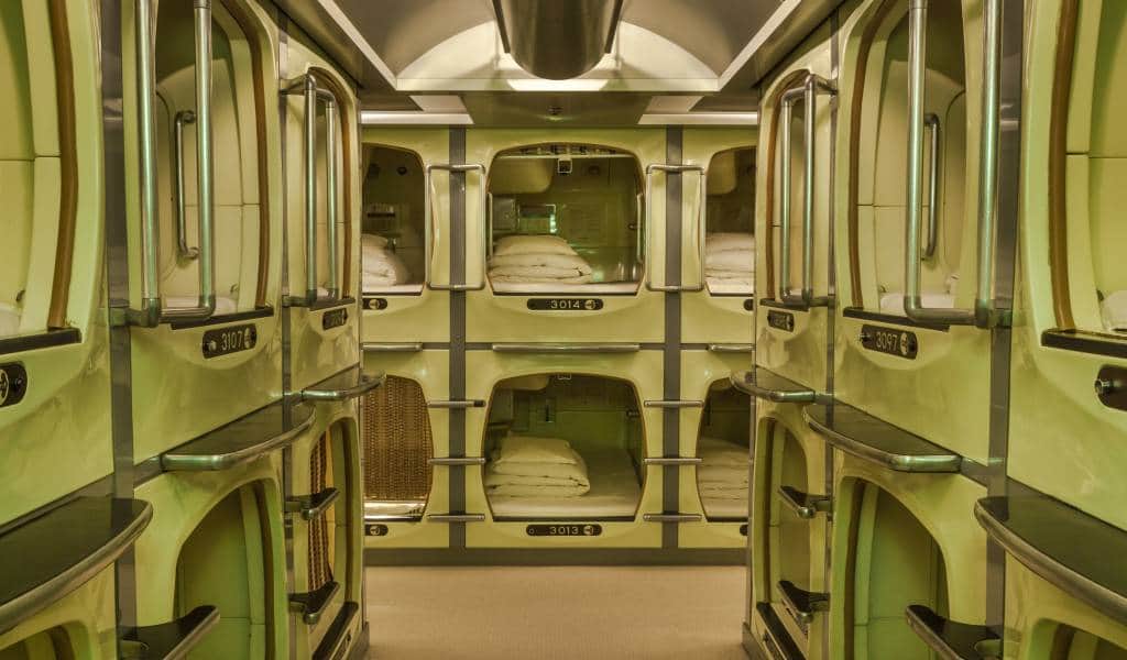 Row of stacked capsule berths on a shared floor in an Asian city hotel