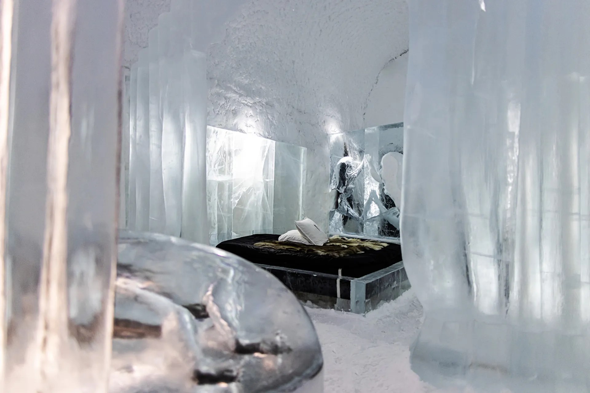 Ice wall lit from within inside a winter ice hotel in northern Scandinavia
