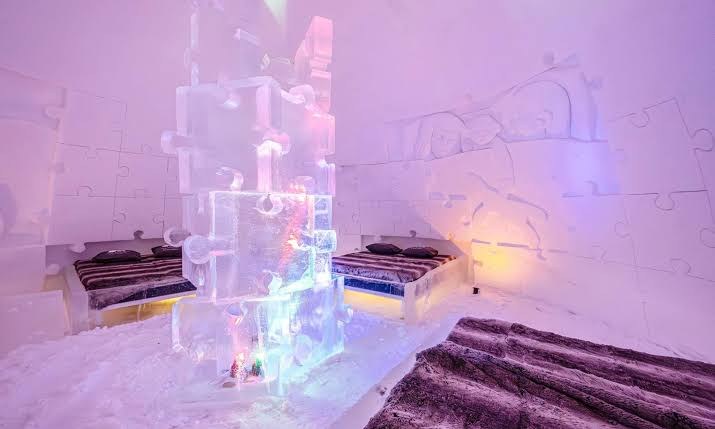 Snow corridor and glass igloos in the forest clearing at Arctic SnowHotel near Rovaniemi